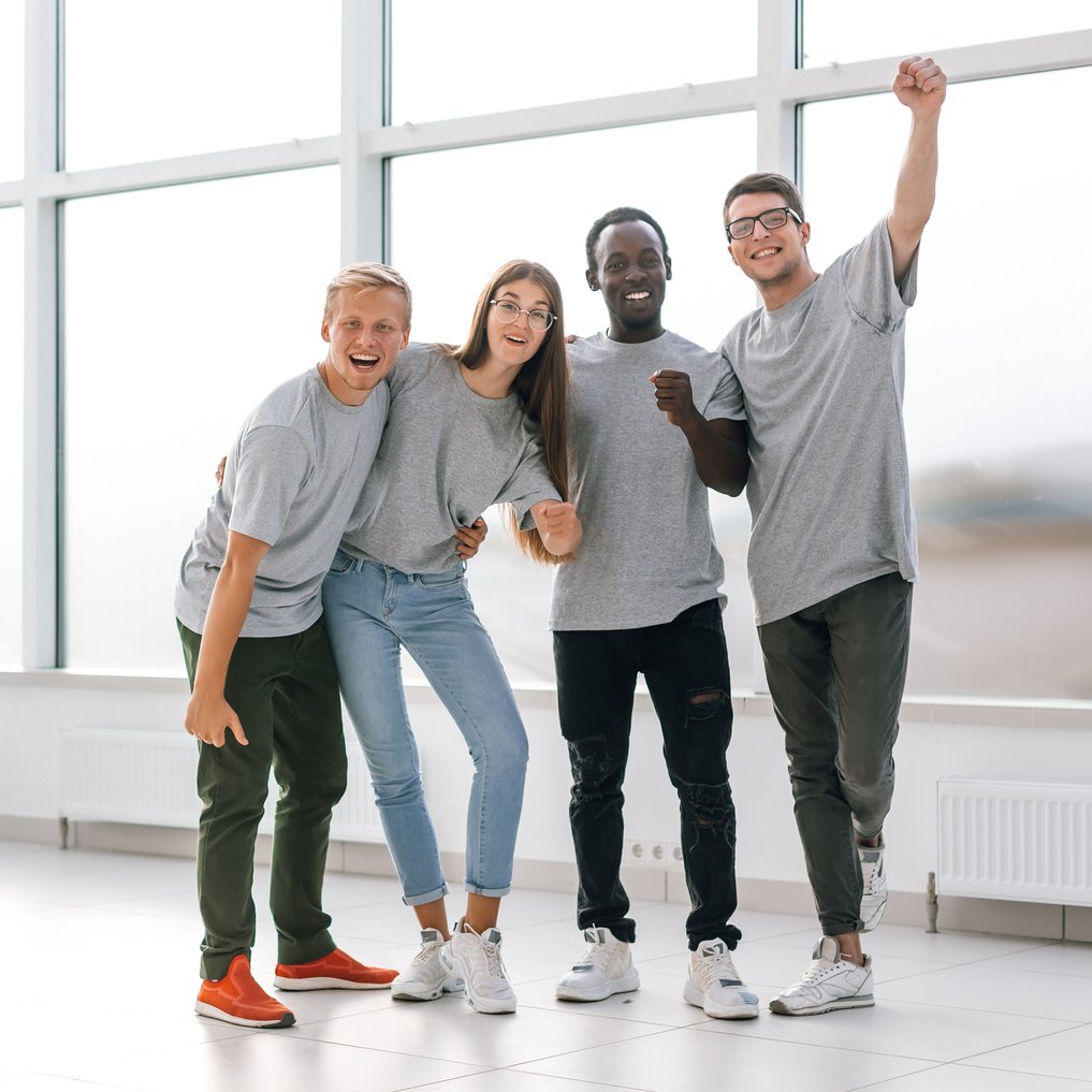happy young employees standing in new office